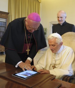 Archbishop Celli helps Pope Benedict XVI with the papal iPad